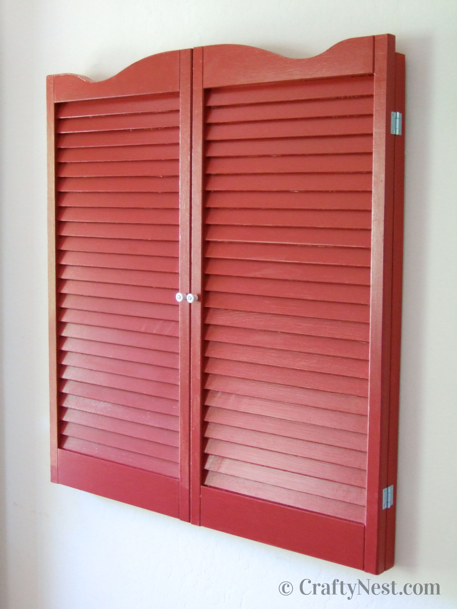 closed-diy-bulletin-board-with-shutters-crafty-nest Red shutters covering a bulletin board, photo