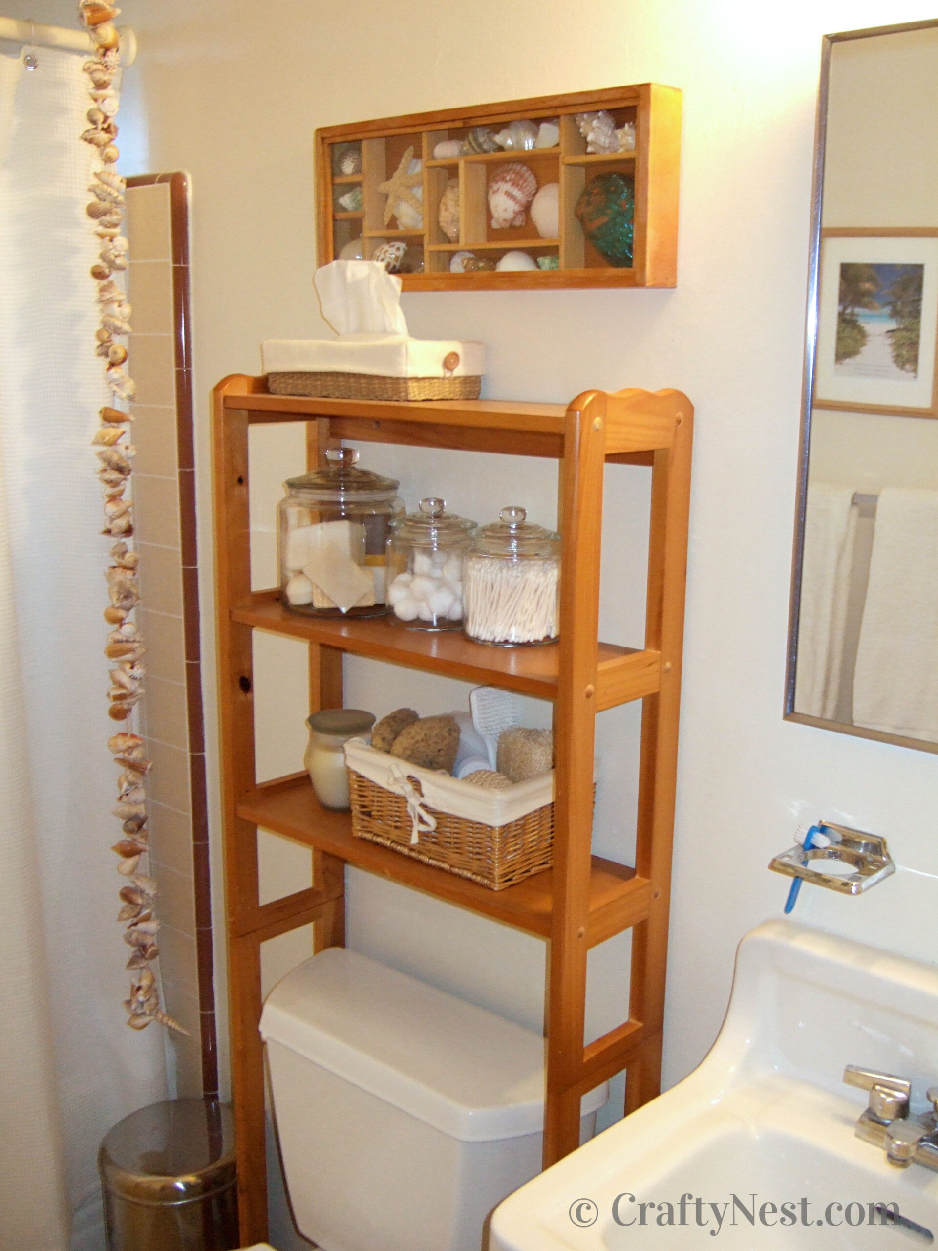after-bathroom-makeover-on-a-budget-crafty-nest Bathroom with shelves, jars, and seashells, photo