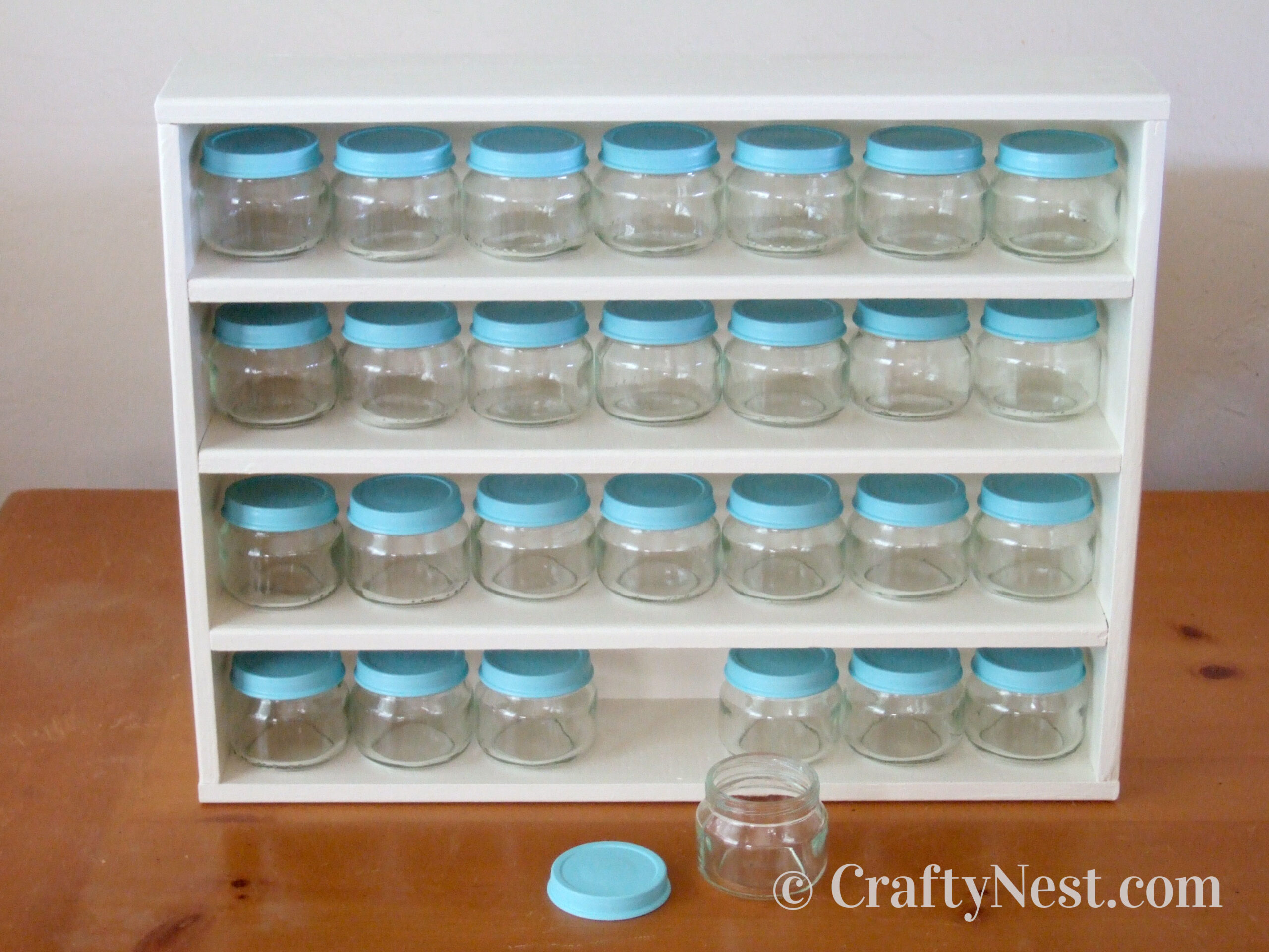 empty-diy-baby-food-jar-craft-rack-crafty-nest Empty baby food jars on custom-built rack, photo