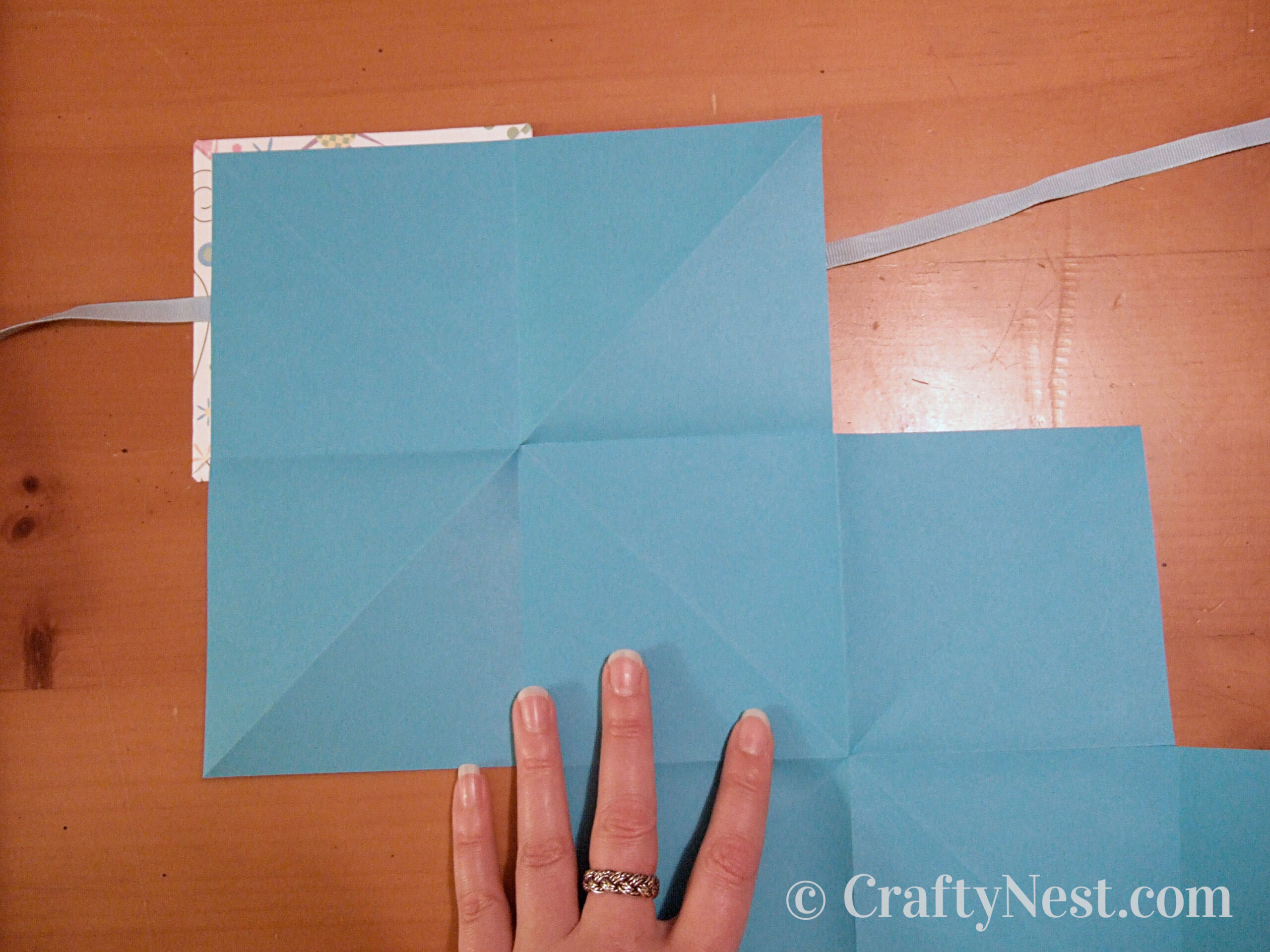 gluing-corners-accordion-books-crafty-nest Glue pages onto inside of front cover, photo