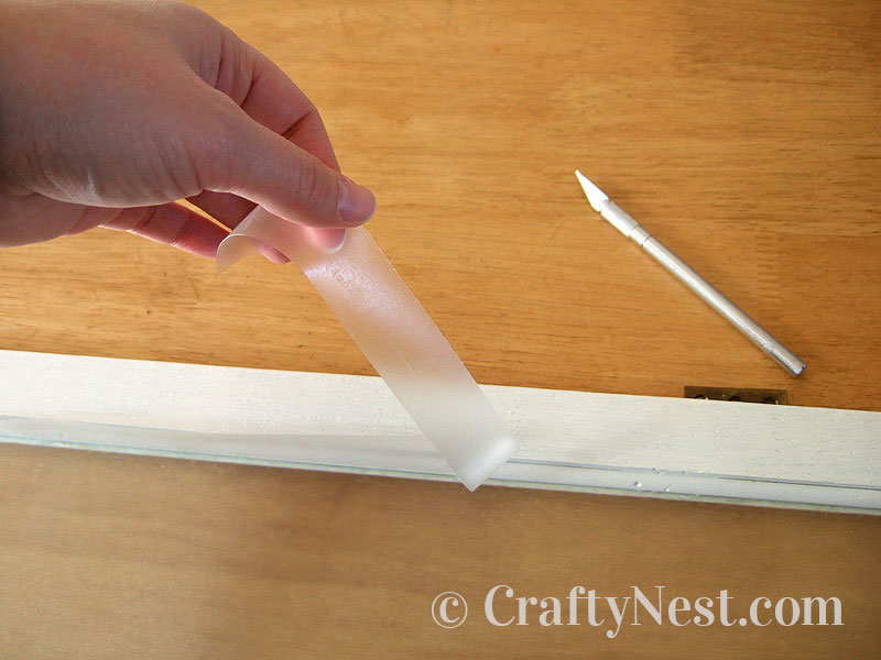 peel-off-diy-faux-frosted-glass-crafty-nest Peeling off the excess of Con-Tact paper, photo