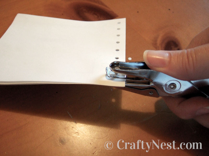 punching-diy-mini-bound-books-crafty-nest Punching holes in sheets of paper, photo