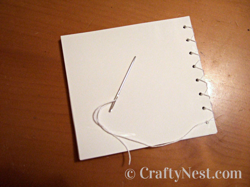 sewing-holes-paper-diy-mini-bound-books-crafty-nest Sewing the pages together, photo