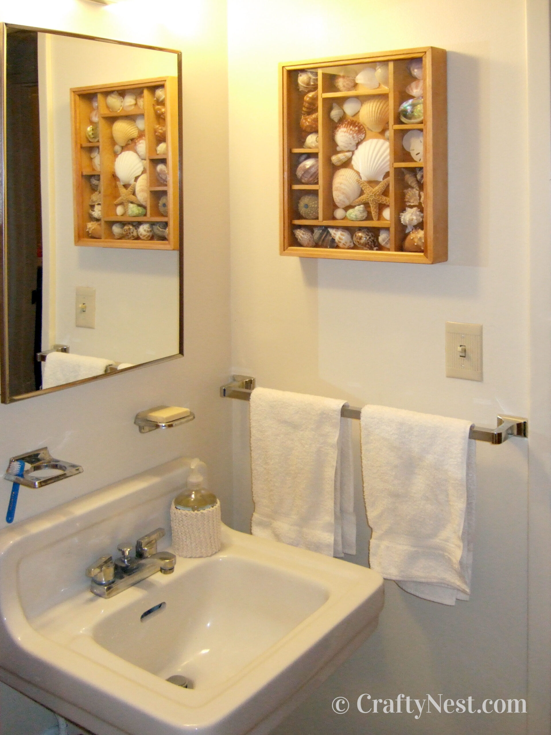 side-bathroom-makeover-on-a-budget-crafty-nest Shadow box with seashells on the bathroom wall, photo