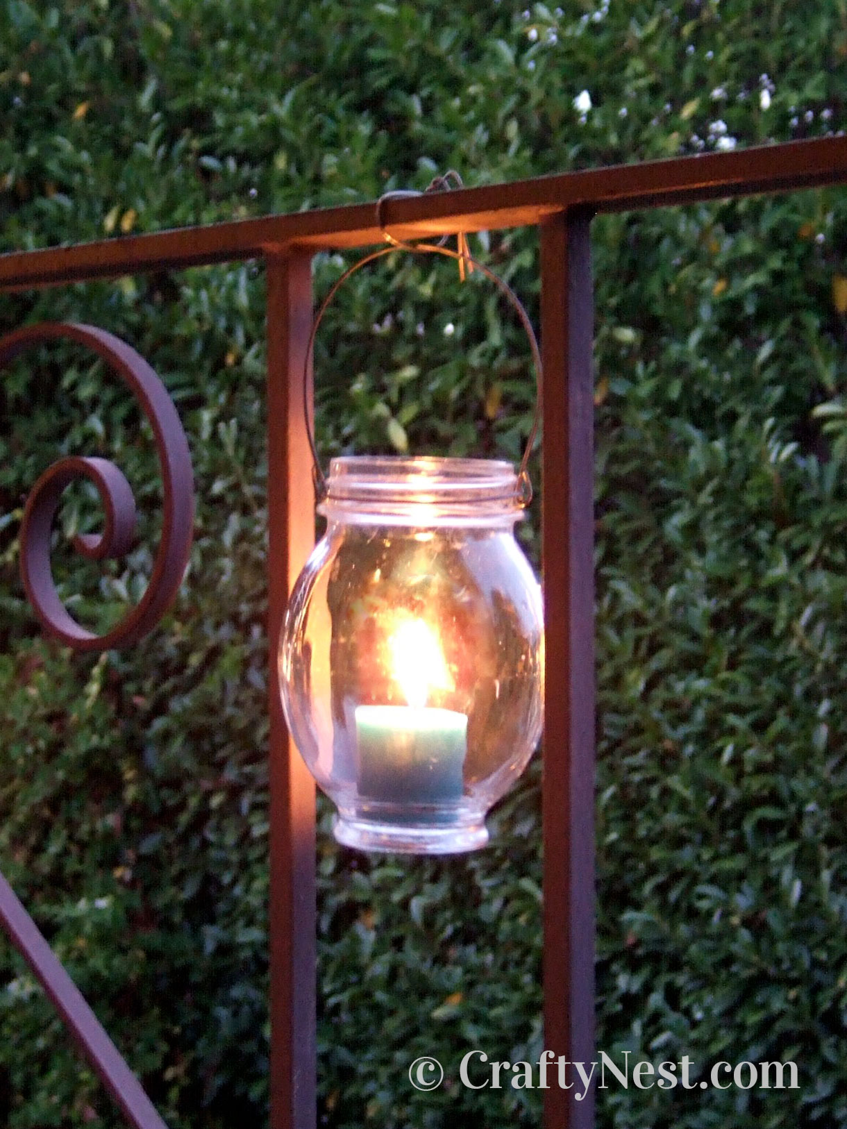 wire-hanging-diy-hanging-jar-lanterns-crafty-nest Hanging the jar from a railing with wire, photo