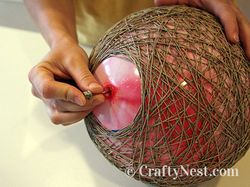 deflate-hemp-pendant-lamps-crafty-nest Use the delating neeedle to deflate the ball, photo