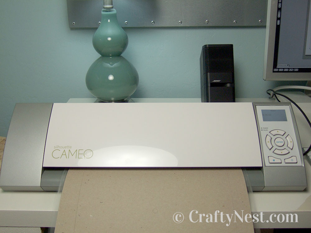 howto2-embossed-numbers-clock-crafty-nest Cutting the cardboard in the Cameo, photo