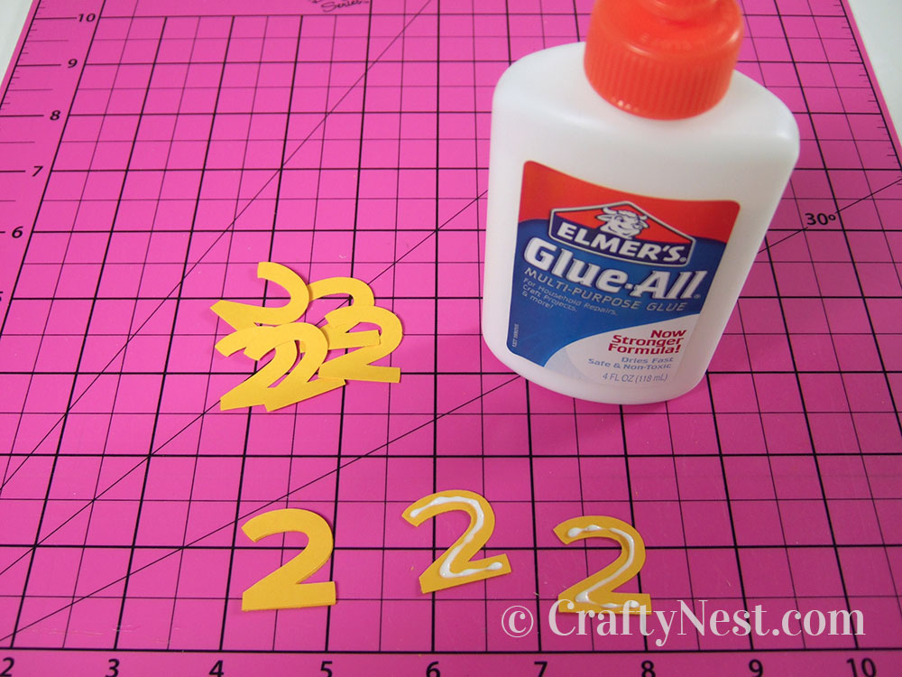 howto8-embossed-numbers-clock-crafty-nest Gluing the numbers back to back, photo