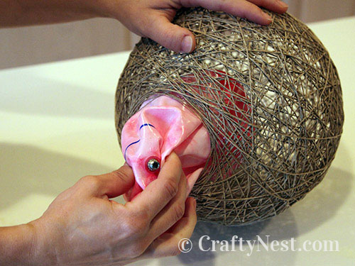 remove-ball-hemp-pendant-lamps-crafty-nest Removing the deflated ball from the string, photo