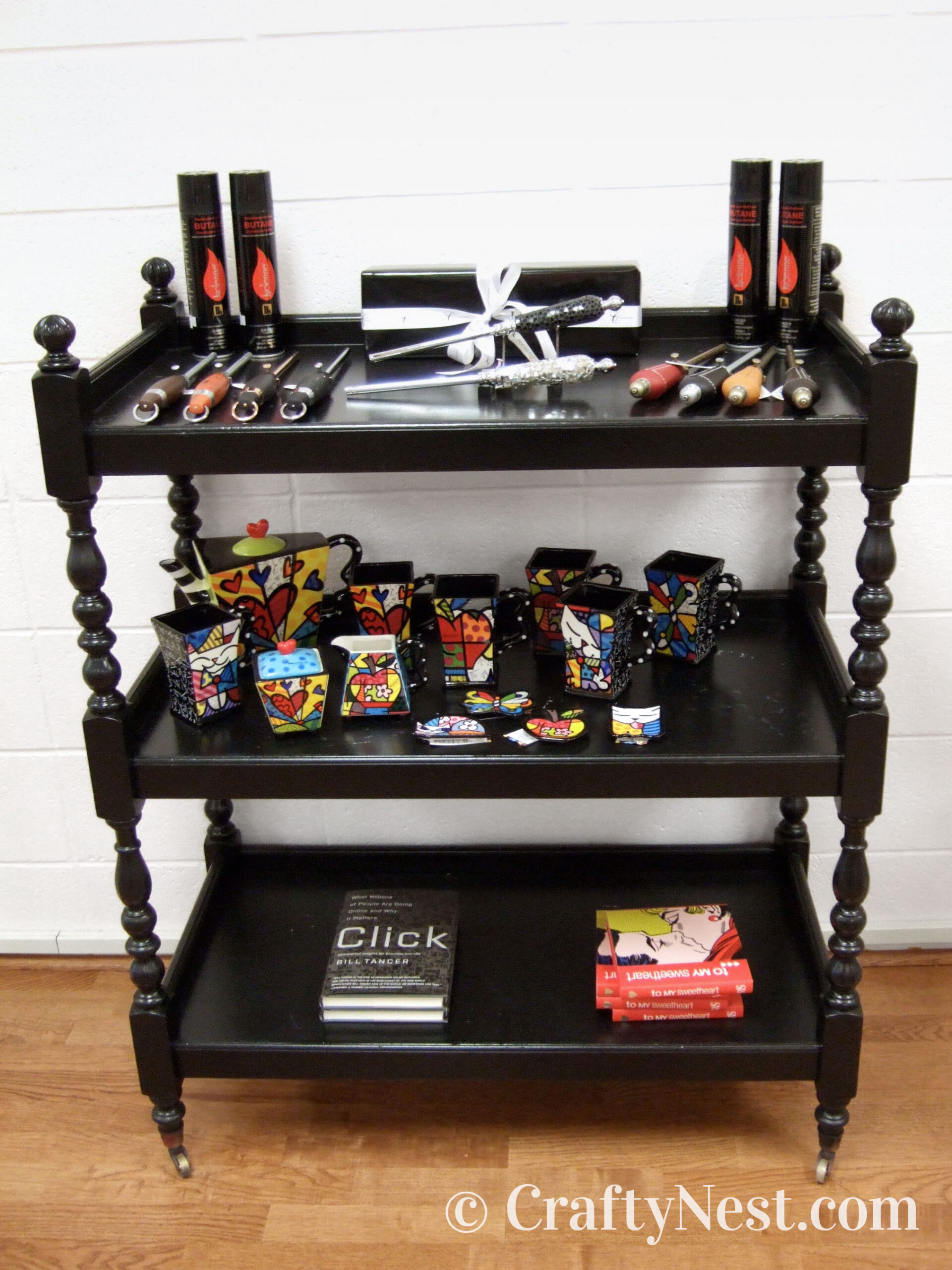 black-shelves-neighborhood-tour-of-crafty-stuff-crafty-nest2 Black cart with things for sale, photo