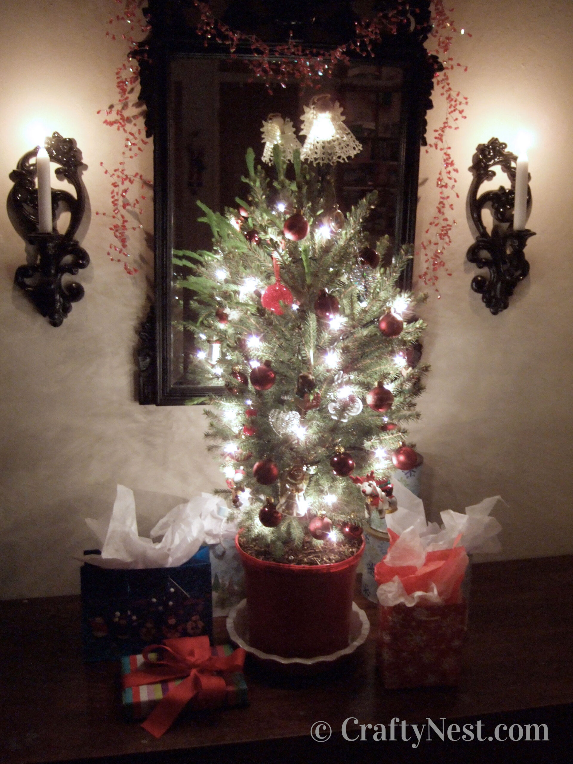 tree-christmas-lights-angel-with-pants-crafty-nest Lights and ornaments on a potted Christmas tree, photo