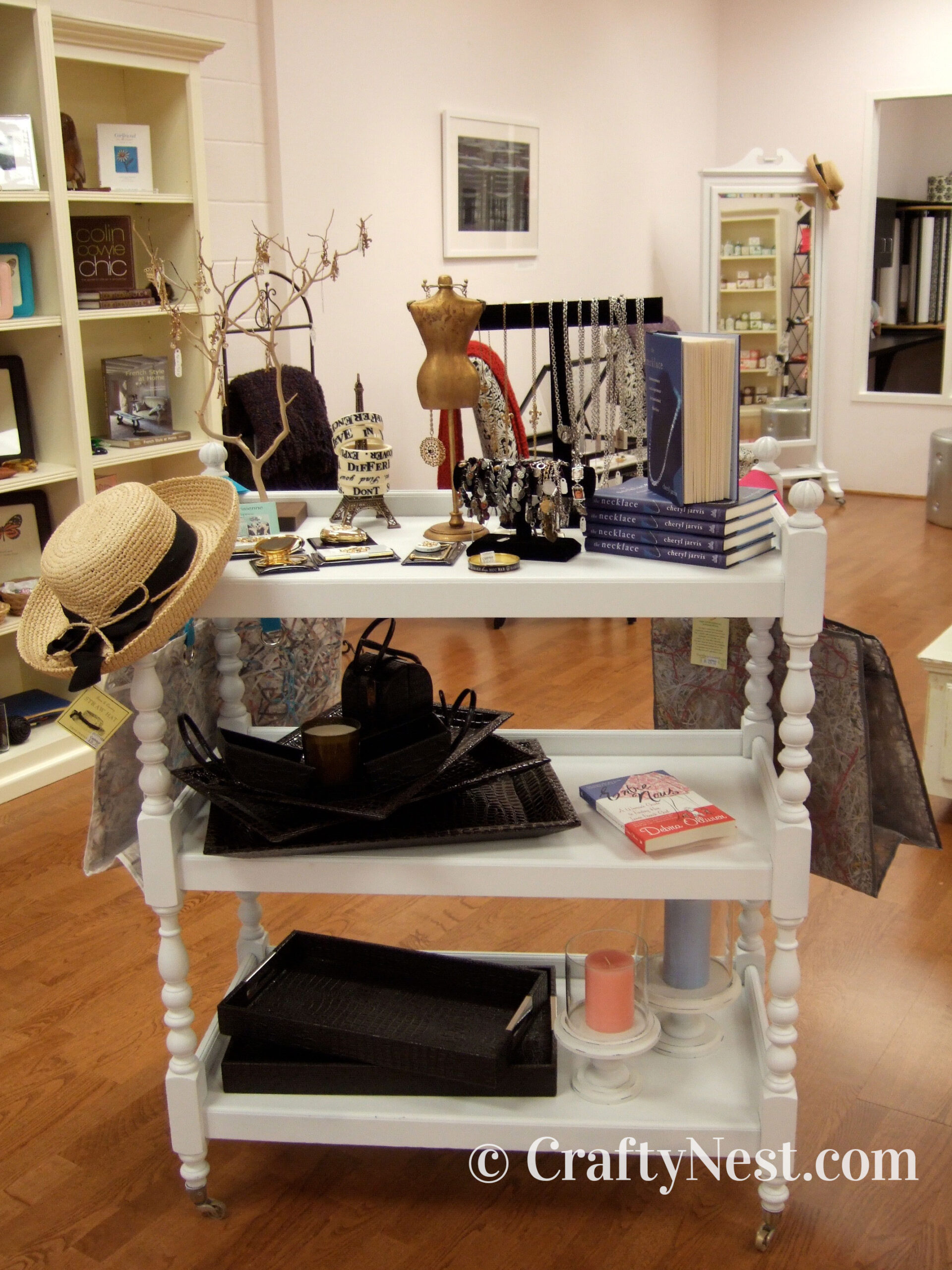 white-shelves-neighborhood-tour-of-crafty-stuff-crafty-nest White shelf with things for sale, photo