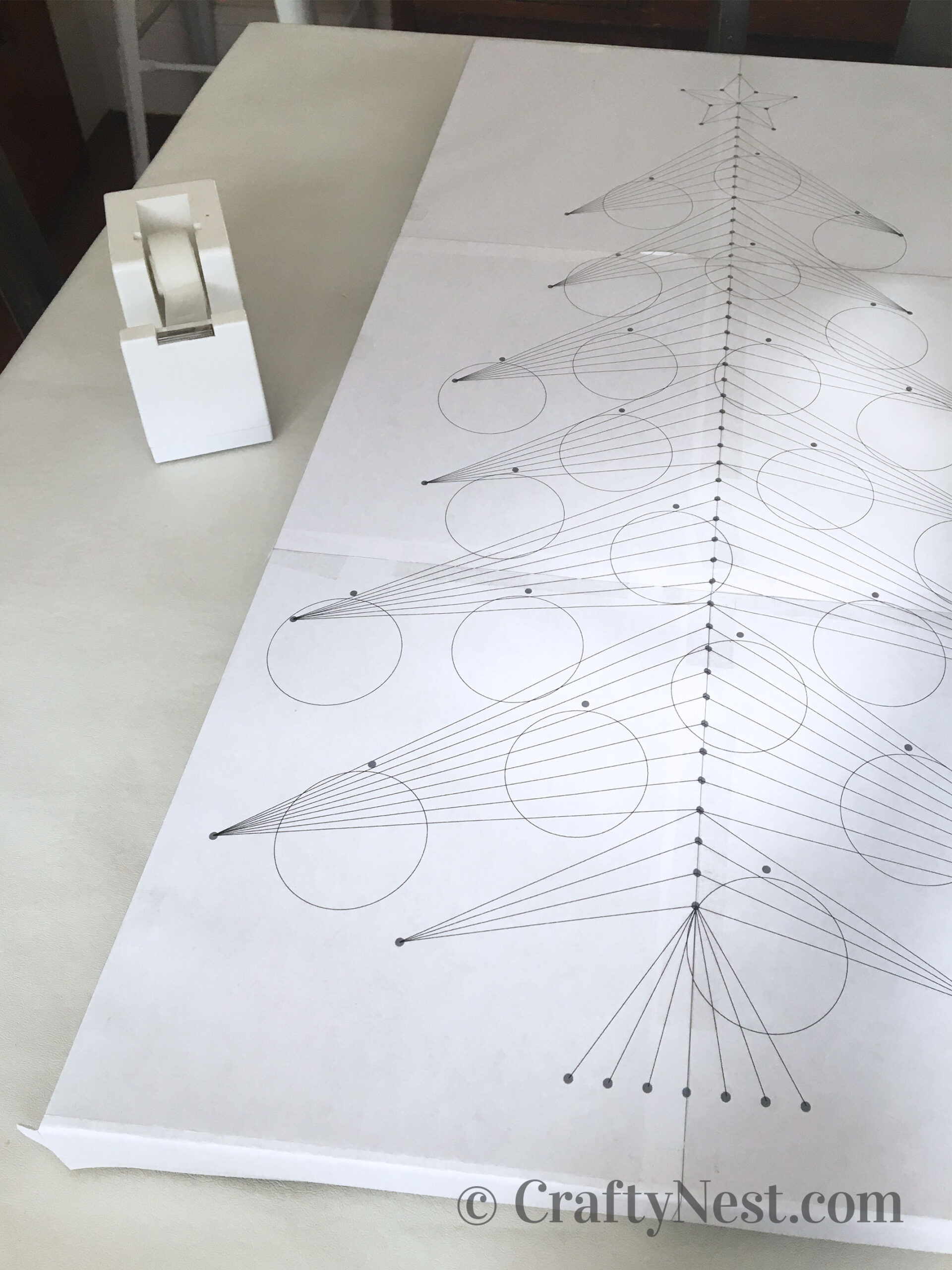 taped-to-wood-advent-calendar-string-art-tree-with-lights-crafty-nest Tape the pattern to the wood, photo