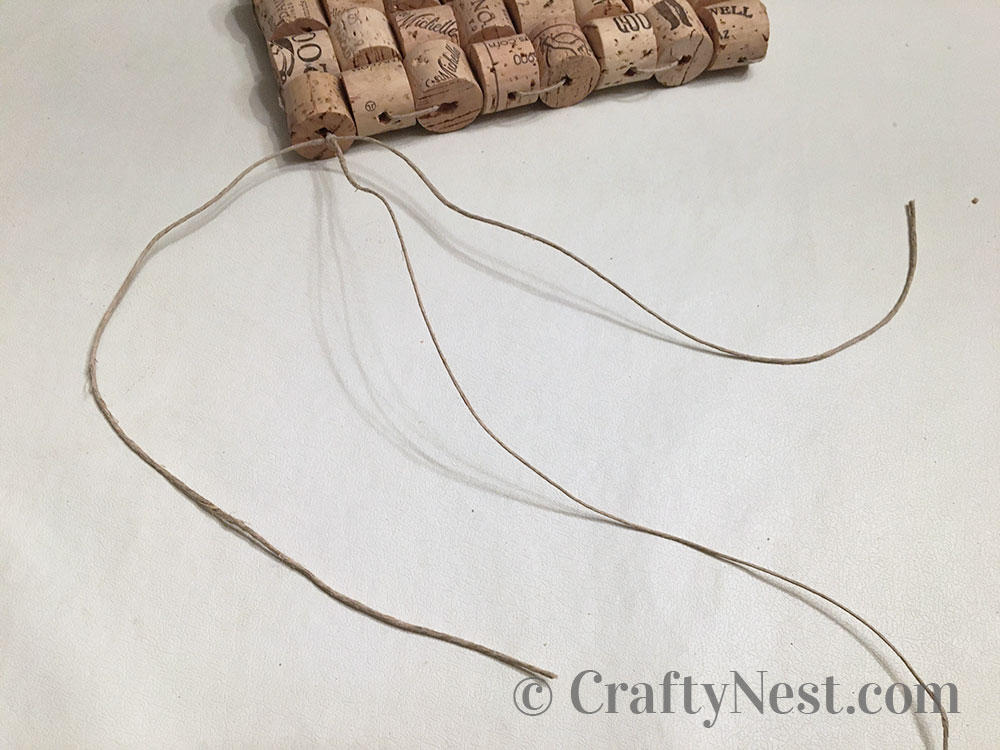 step12-woven-wine-cork-trivet-crafty-nest Tie on another piece of string, photo