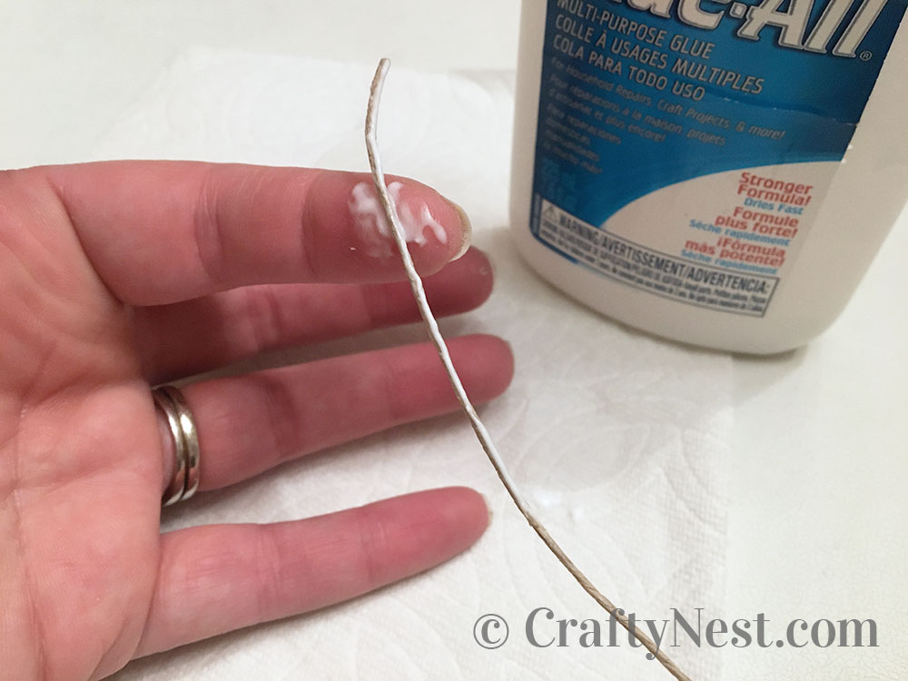 step4-woven-wine-cork-trivet-crafty-nest Applying glue to the hemp string, photo