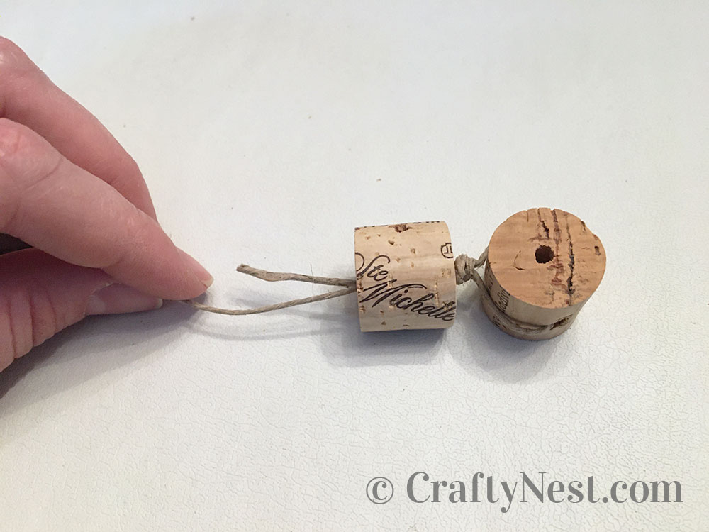 step6-woven-wine-cork-trivet-crafty-nest Stringing the second cork, photo