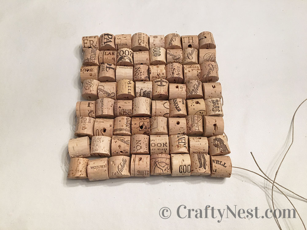 step9-woven-wine-cork-trivet-crafty-nest Corks arranged into a square shape, photo